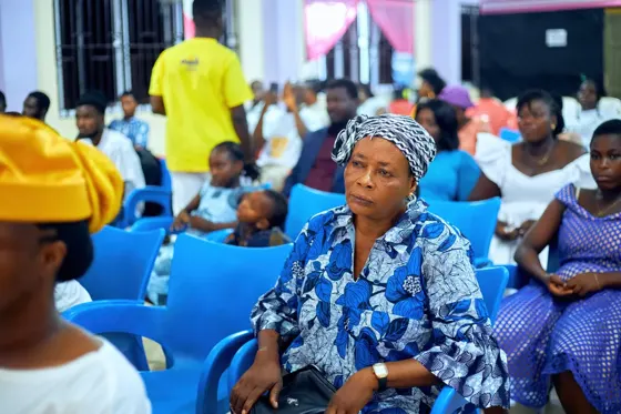 Adults seated in the church congregation during the event