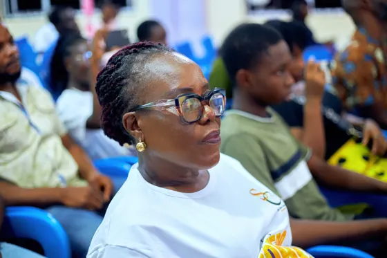 A seated attendee wearing glasses during the church gathering